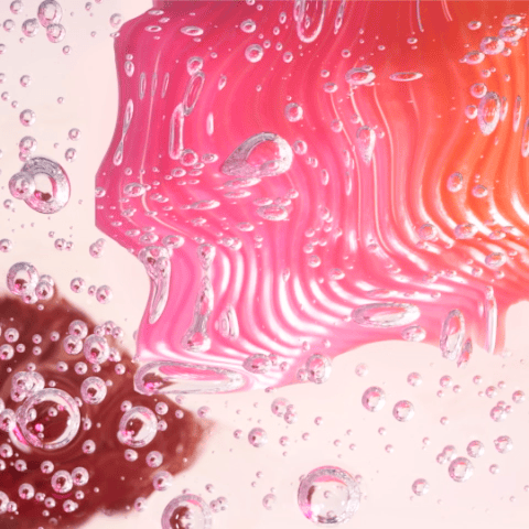 Magenta-pink photo of glass blob with distorting blob