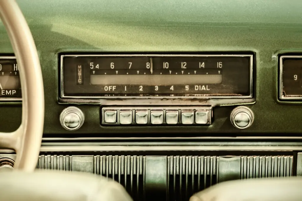 Vintage car dashboard radio, green and cream colored
